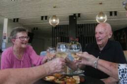 old woman and man celebrating in a perfect retirement village