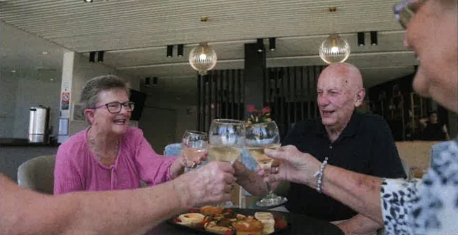 old woman and man celebrating in a perfect retirement village