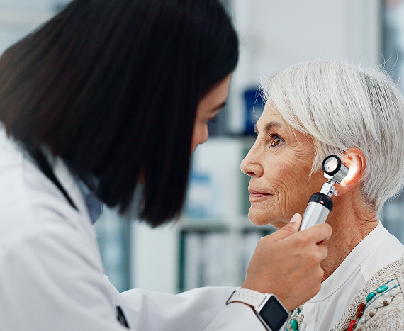 senior-woman-doctor-otoscope-ear-hearing-test-exam-audio 1